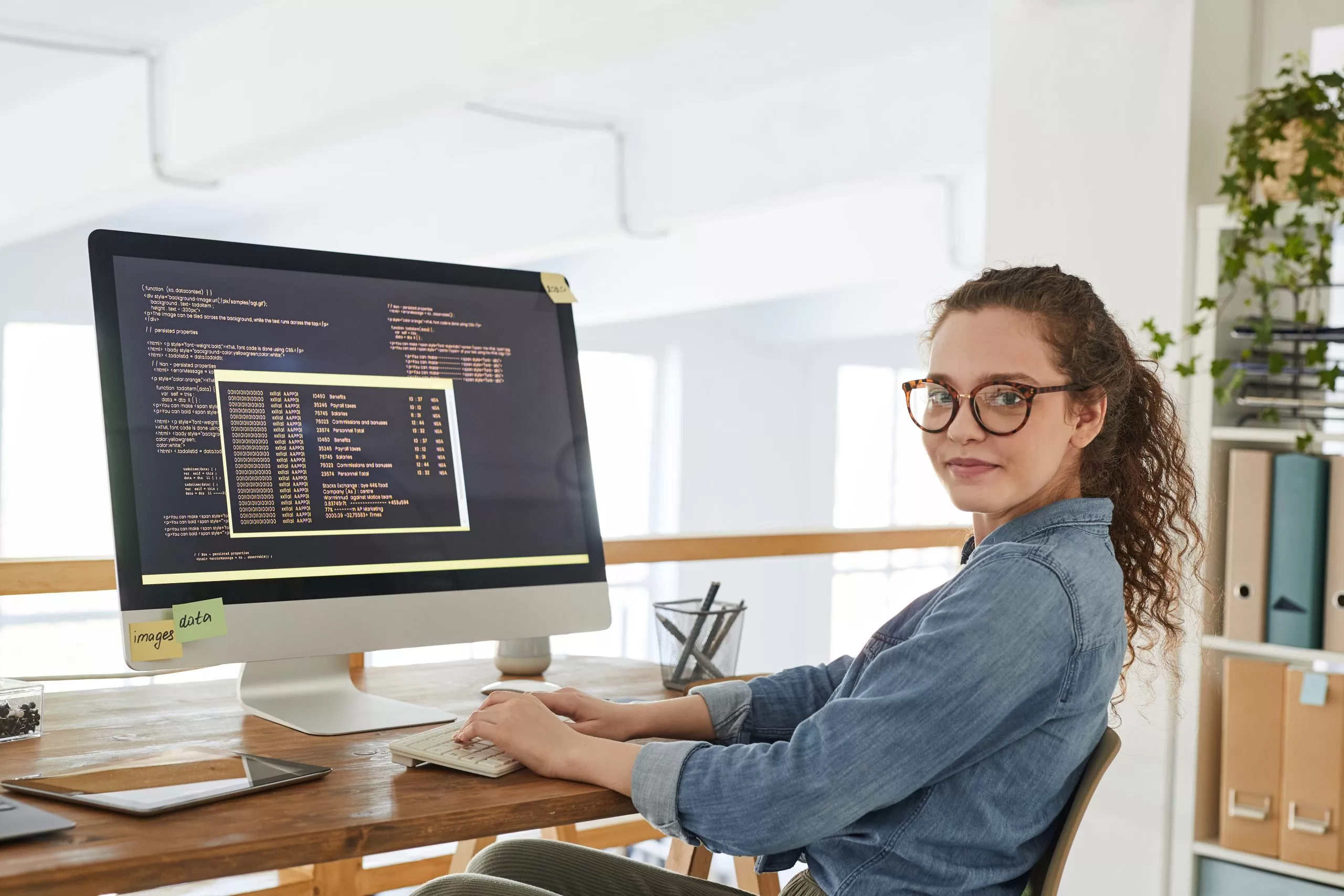 Young Woman Writing Code in Office